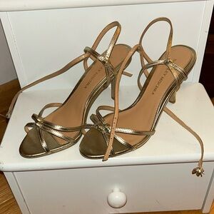 Gold strappy sandals , light wear shown on one heel